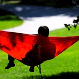 A student relaxes in a hammock on central campus at ISU.