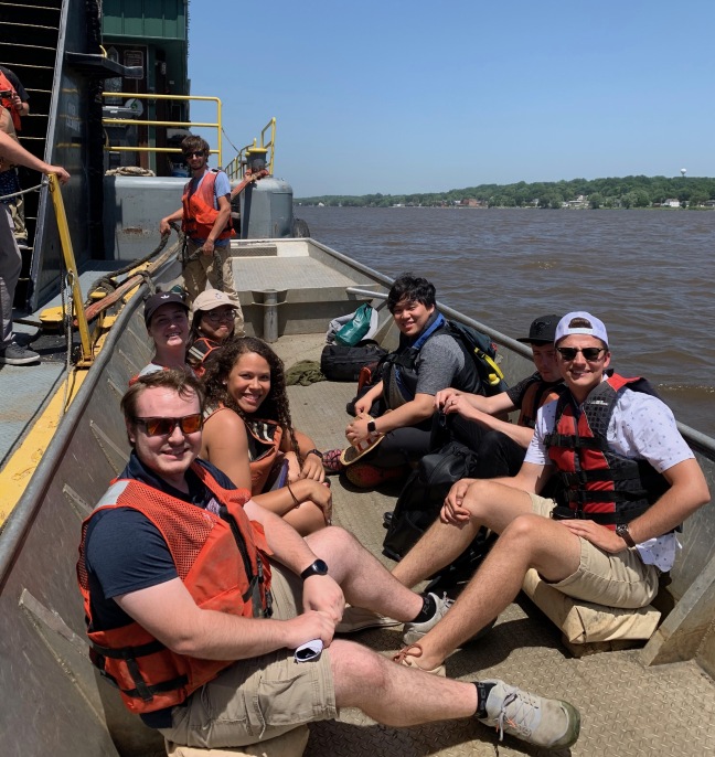 Students ride a barge on their way to a landscape architecture workshop
