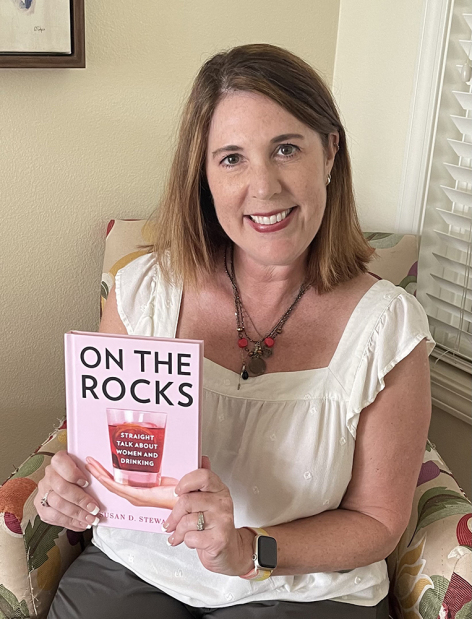 Sociology Professor Susan Stewart holds her newly published book “On the Rocks: Straight talk about women and drinking.”