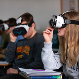 Iowa State students in Spanish 304, taught by Spanish lecturer James Nemiroff, use virtual reality headsets during a class presentation in 2020.