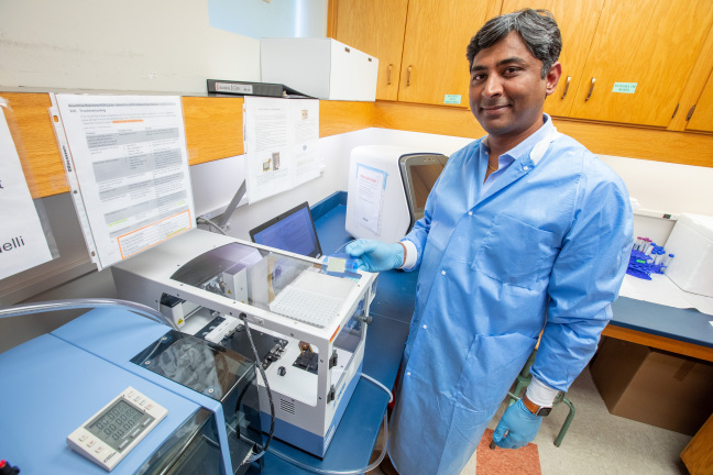 Rahul Nelli holds a SmartChip in his lab