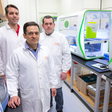 Researchers Daniel Linhares, front, with Guilherme Cezar, back left, and Giovani Trevisan in a veterinary diagnostic lab.