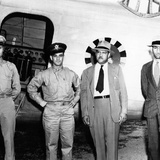 Patterson posing by airplane with military personnel 