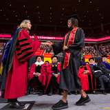 President Wintersteen shakes hands with students at fall 2022 commencement