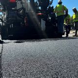 A paving crew puts down a test section of soybean-based asphalt in Virginia as part of a long-term performance study by the Federal Highway Administration.
