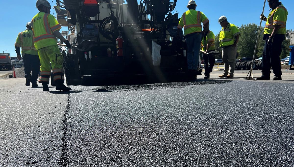 A paving crew puts down a test section of soybean-based asphalt in Virginia as part of a long-term performance study by the Federal Highway Administration.