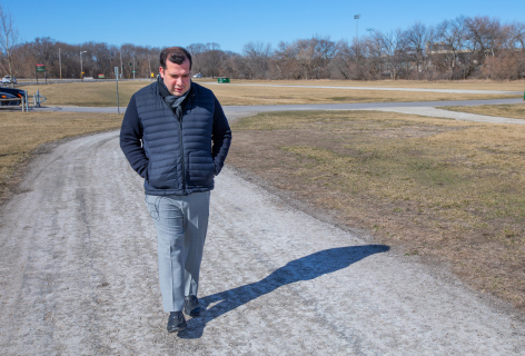 Nacu Hernandez strolls down a path paved with asphalt near the ISU campus.