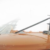 A view from a snowplow cab during a snow storm.